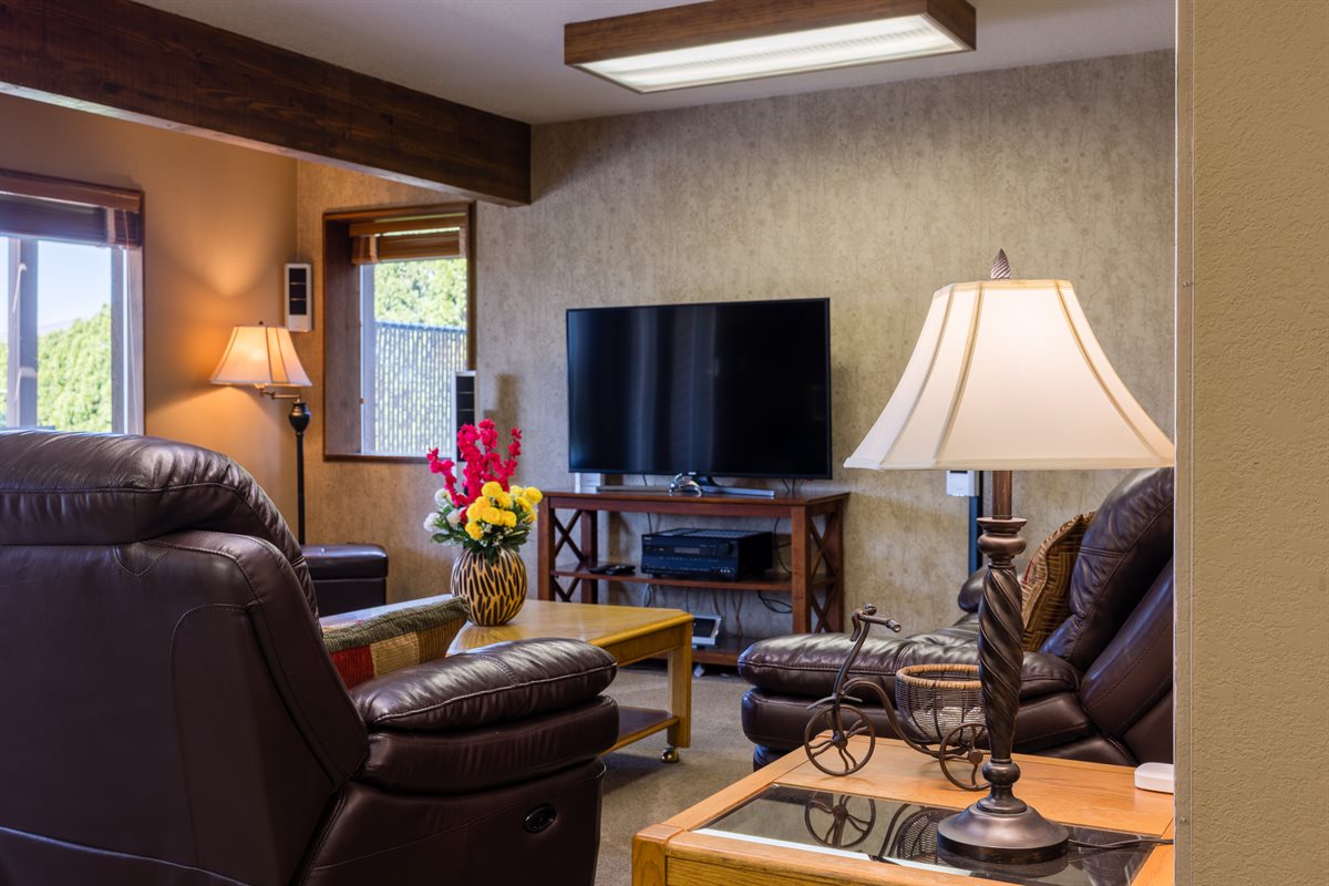 Basement entertainment area with kitchenette